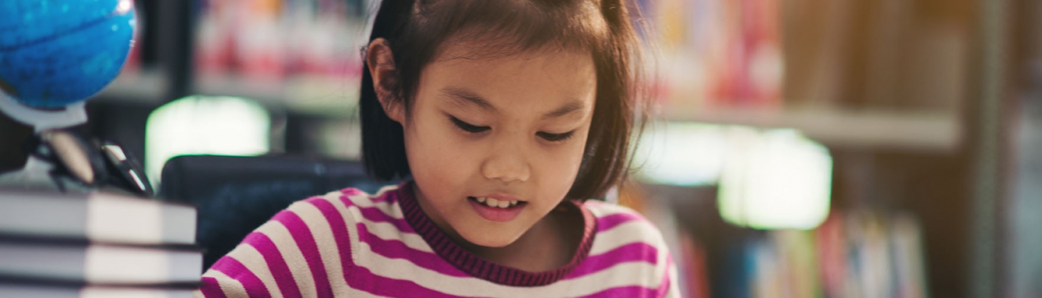 Portrait of a student child girl studying at library tuition class